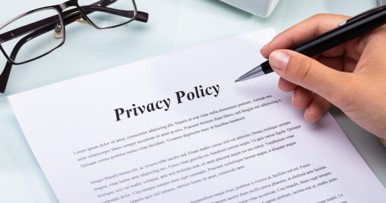 Woman holding pen over paper privacy policy